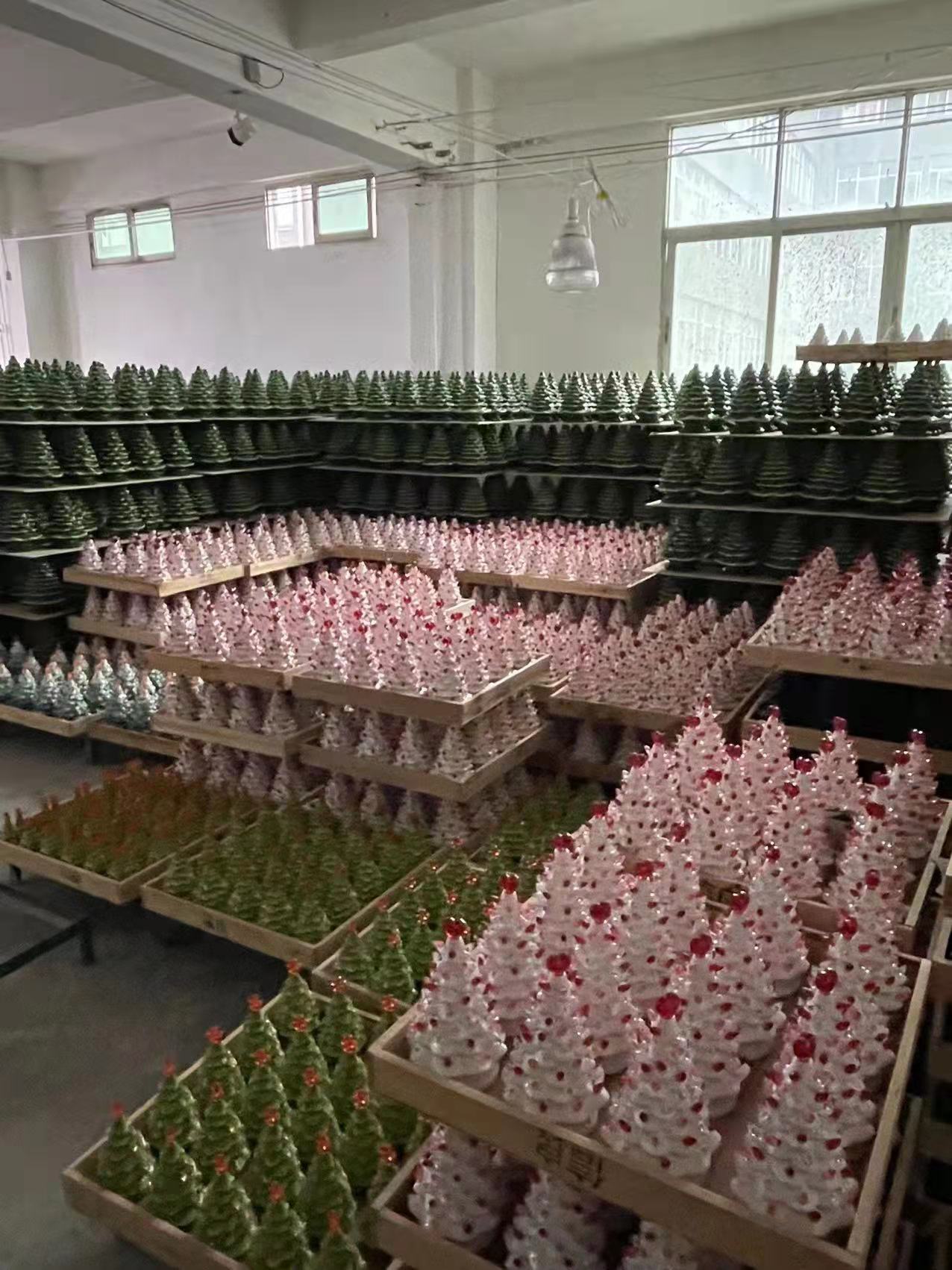 Rows of hand-decorated ceramic Christmas trees staged on shelves in our Dehua warehouse before shipment